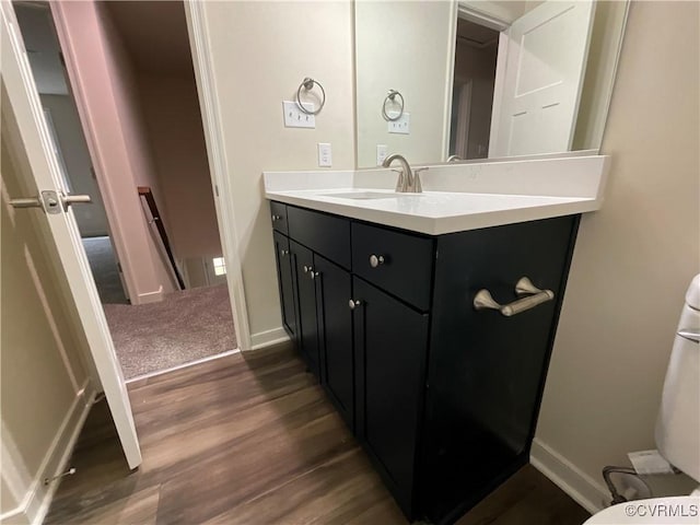 1841 Walkerton Rd, Chesterfield, VA 23236 - bathroom with wood finished floors, vanity, baseboards, and toilet