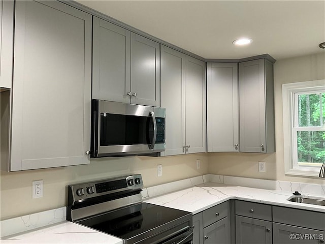 1841 Walkerton Rd, Chesterfield, VA 23236 - kitchen featuring stainless steel microwave, range with electric stovetop, gray cabinets, a sink, and light stone countertops