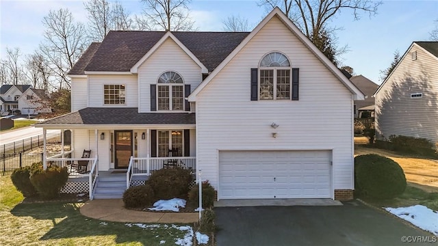 view of front facade featuring a porch, a garage, and a front yard