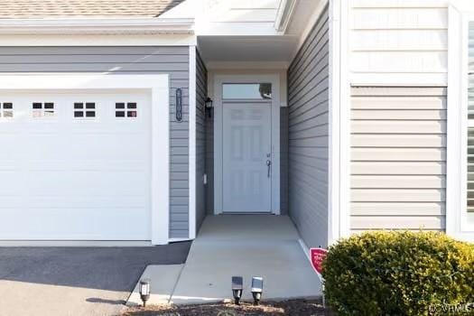 doorway to property featuring a garage