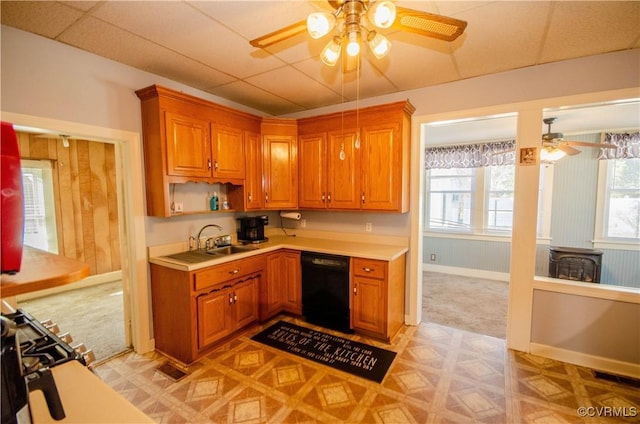 kitchen with sink, light colored carpet, dishwasher, and ceiling fan