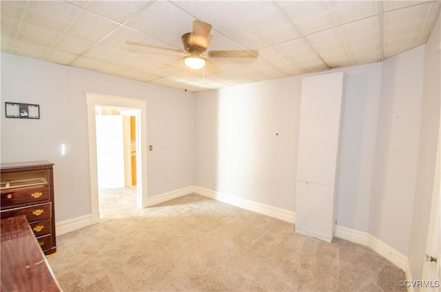 unfurnished bedroom with ceiling fan and light colored carpet