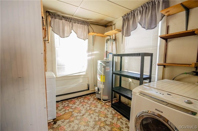 clothes washing area with baseboard heating, wooden walls, washer / dryer, and gas water heater