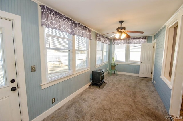 sunroom / solarium featuring ceiling fan