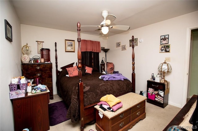 bedroom with light carpet and ceiling fan