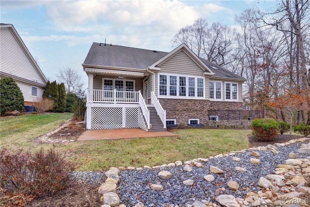 back of house with cooling unit, a yard, a patio, and covered porch