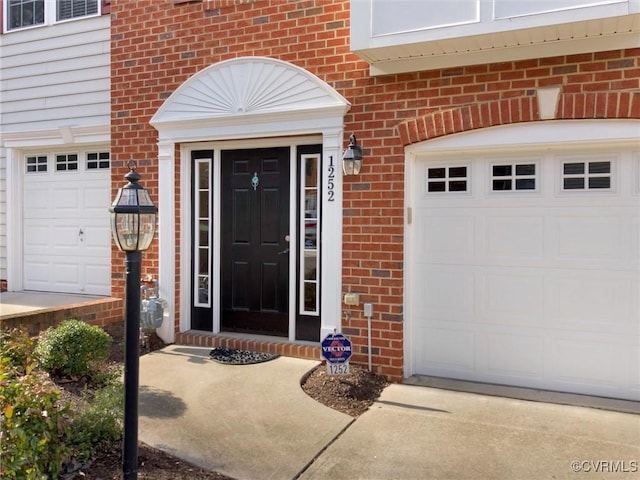 view of exterior entry with a garage