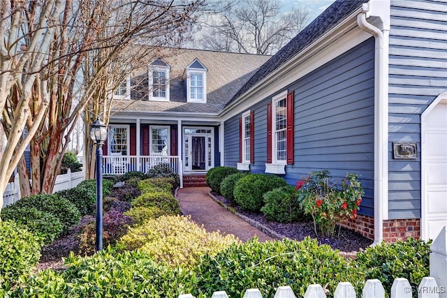 view of front of home featuring a porch and a garage