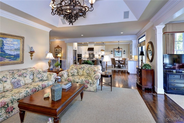 living room featuring visible vents, dark wood finished floors, ornamental molding, an inviting chandelier, and a tray ceiling