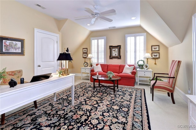 living area featuring carpet, lofted ceiling, visible vents, ceiling fan, and baseboards