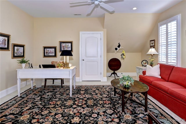 home office with lofted ceiling, a ceiling fan, visible vents, and baseboards