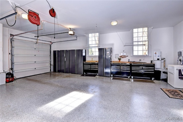 garage featuring washer / clothes dryer and a garage door opener