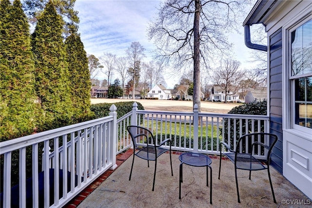 balcony featuring covered porch and a residential view