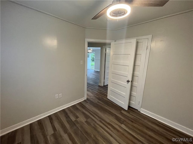 unfurnished room featuring ceiling fan and dark hardwood / wood-style floors