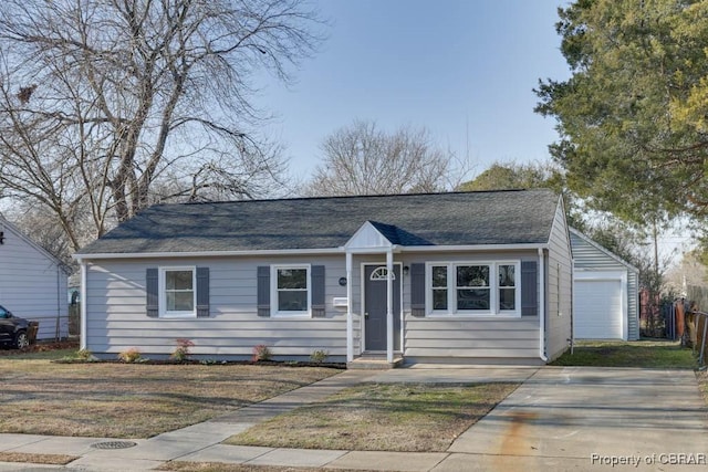 view of front of home featuring a garage and an outbuilding