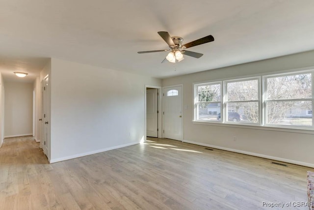 spare room featuring ceiling fan and light wood-type flooring