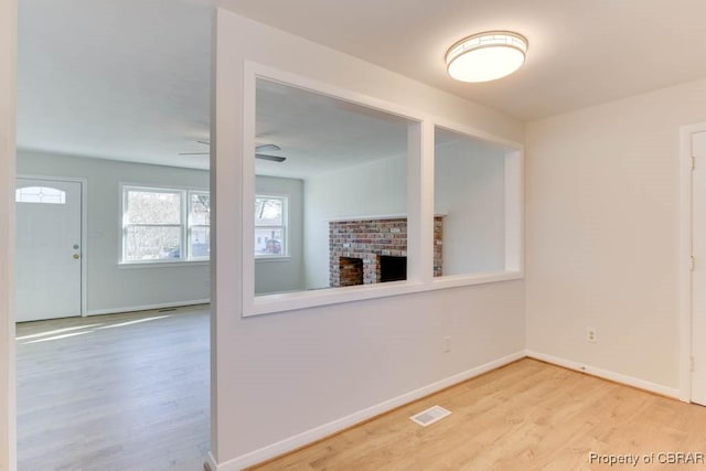 unfurnished living room featuring hardwood / wood-style floors and ceiling fan