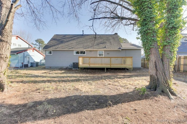 back of house with a wooden deck and cooling unit