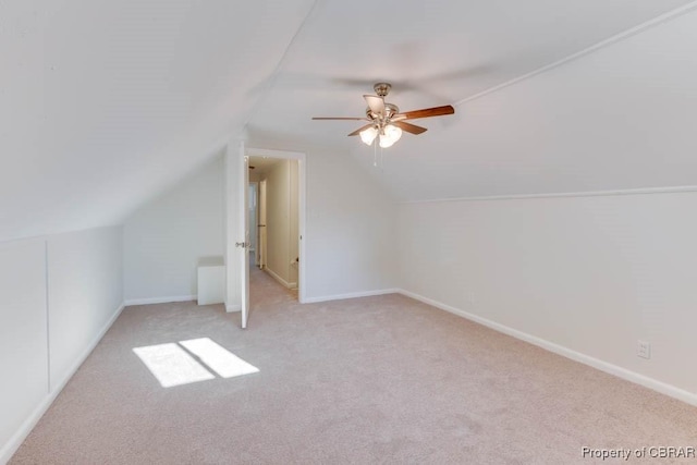 bonus room with light carpet, lofted ceiling, and ceiling fan