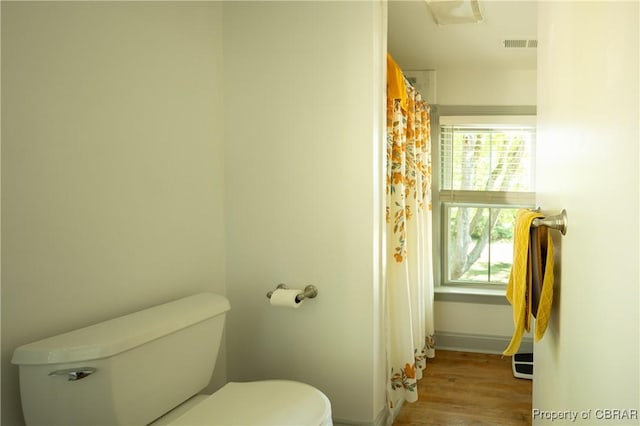 bathroom featuring hardwood / wood-style floors and toilet