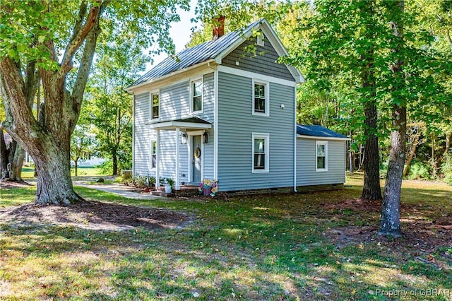 back of house with a lawn