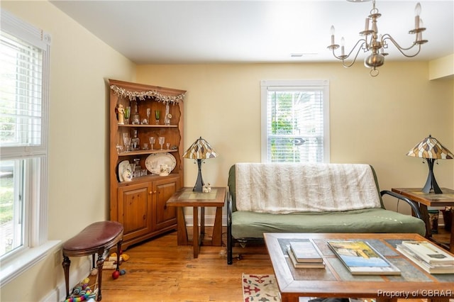 sitting room featuring a chandelier and light hardwood / wood-style floors