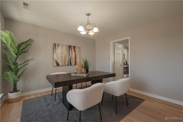 dining room featuring an inviting chandelier and light hardwood / wood-style floors