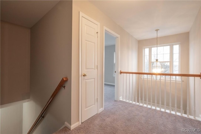 hallway featuring light colored carpet