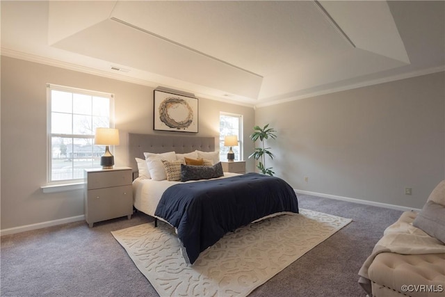 carpeted bedroom with ornamental molding and a raised ceiling