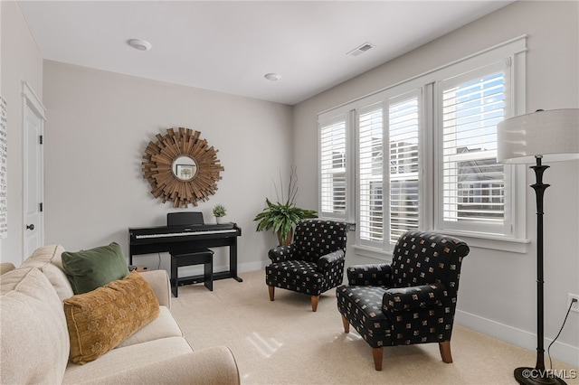 living area featuring light carpet