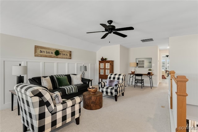 carpeted living room with vaulted ceiling and ceiling fan