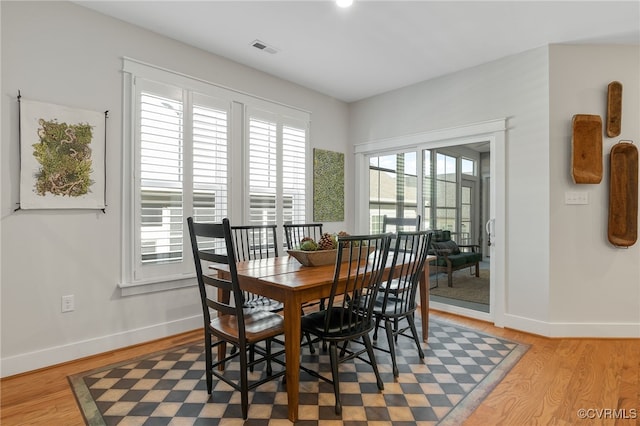 dining space with wood-type flooring