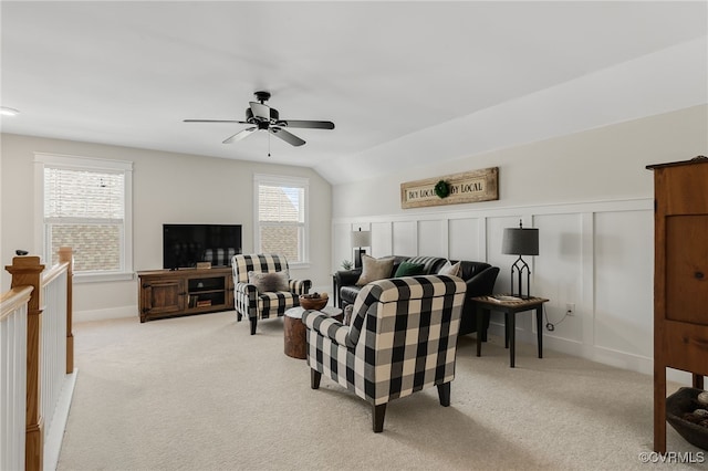 carpeted living room with lofted ceiling and ceiling fan