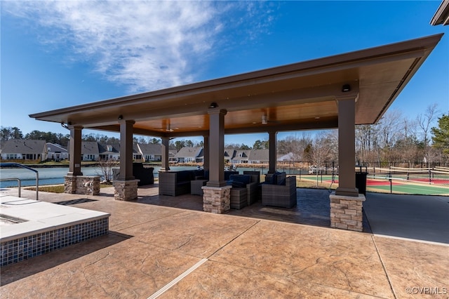 view of patio / terrace featuring outdoor lounge area and tennis court