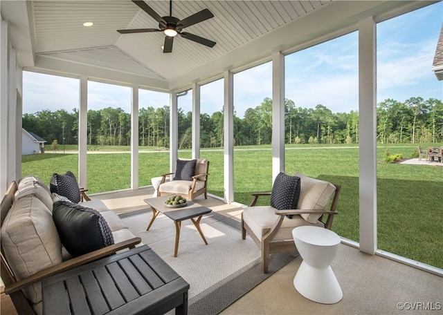 sunroom featuring lofted ceiling and ceiling fan