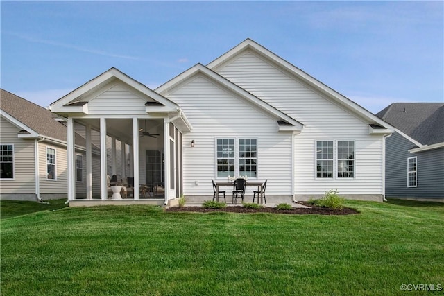 rear view of property featuring a yard, a patio area, and a sunroom