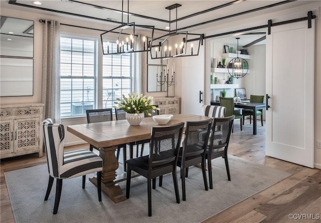 dining room featuring wood-type flooring and a barn door