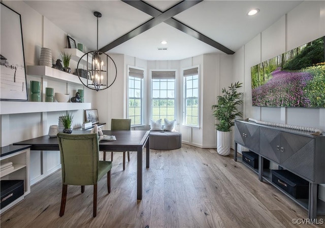 dining space featuring an inviting chandelier, hardwood / wood-style floors, and beam ceiling