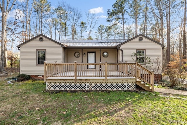 view of front facade featuring a front yard and a deck