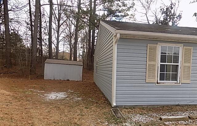 view of home's exterior with a shed