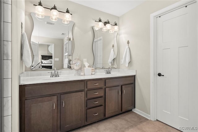 bathroom with tile patterned floors and vanity