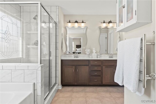 bathroom with vanity, shower with separate bathtub, and tile patterned flooring