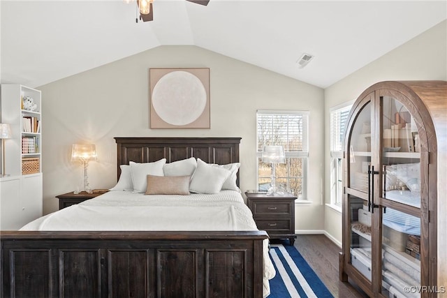 bedroom featuring multiple windows, dark wood-type flooring, lofted ceiling, and ceiling fan