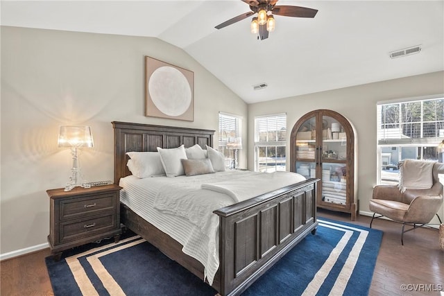 bedroom with ceiling fan, lofted ceiling, dark hardwood / wood-style floors, and multiple windows