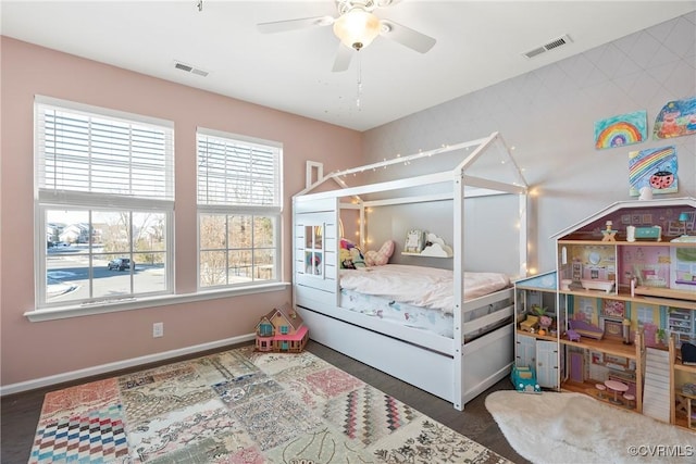 bedroom featuring multiple windows, dark hardwood / wood-style floors, and ceiling fan