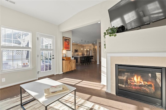 unfurnished living room with lofted ceiling and hardwood / wood-style floors