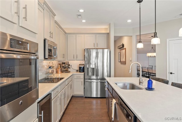 kitchen with sink, wine cooler, backsplash, hanging light fixtures, and stainless steel appliances