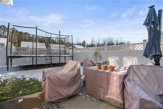 view of patio featuring a trampoline and grilling area