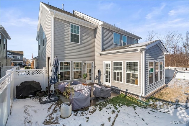 view of snow covered rear of property