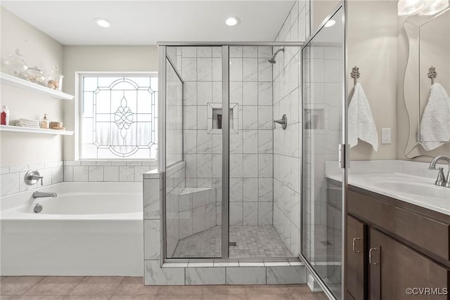 bathroom featuring tile patterned flooring, vanity, and shower with separate bathtub